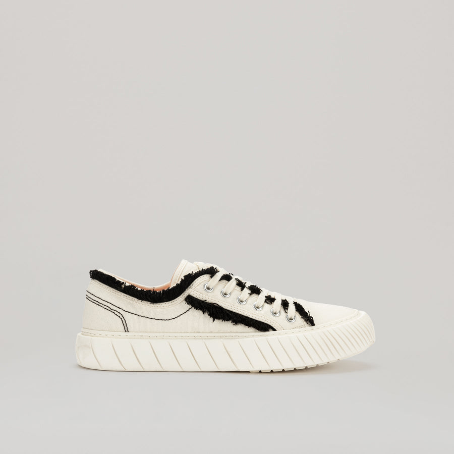both - FORMULA LOW white sneaker with black fringe hem and durable EVA rubber sole