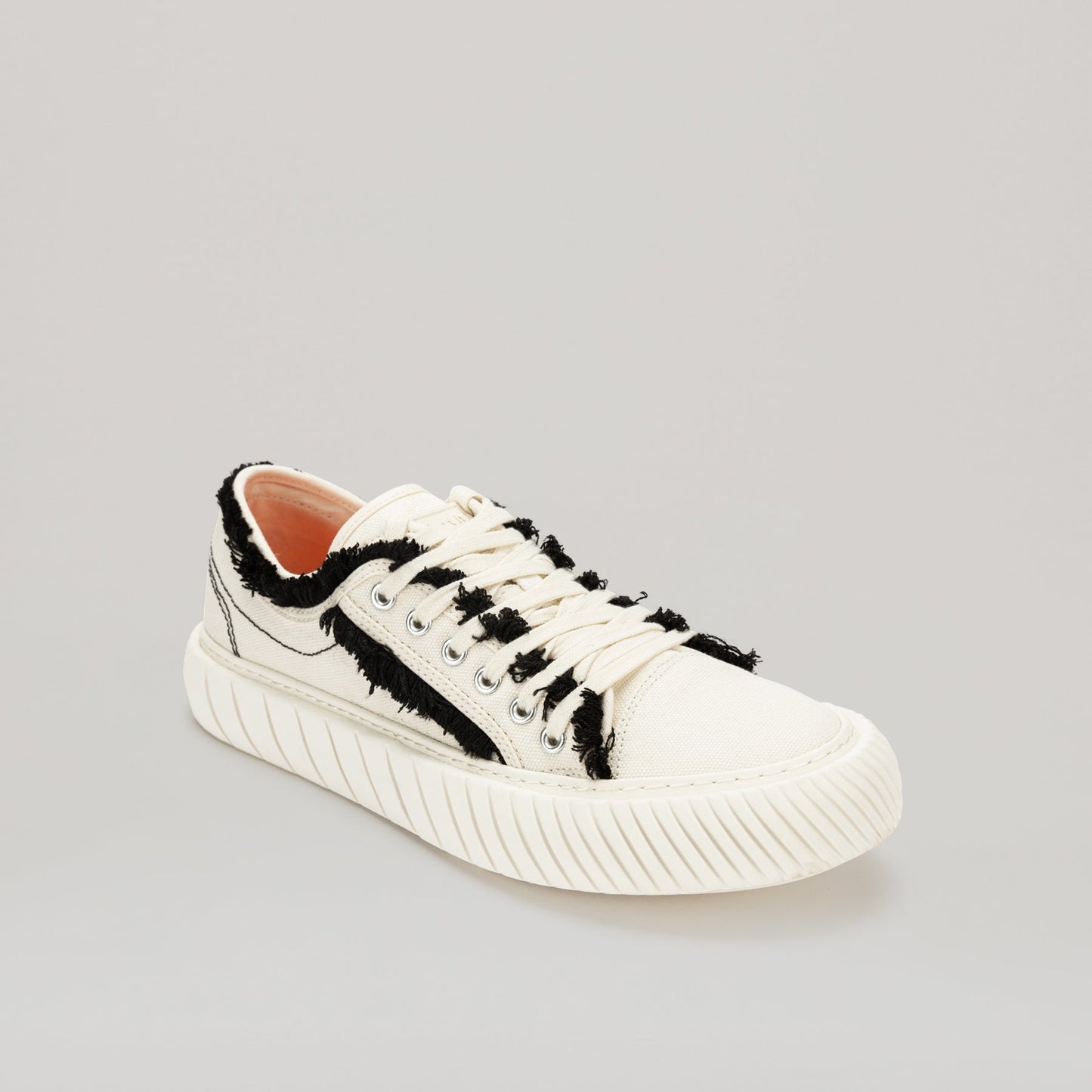 both FORMULA LOW white canvas sneakers with black fringe hem and EVA rubber sole