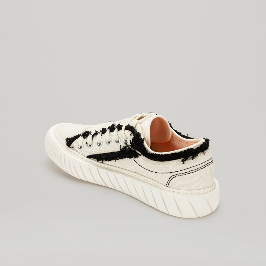 White FORMULA LOW sneaker with black fringe hem and EVA rubber sole for comfort and style