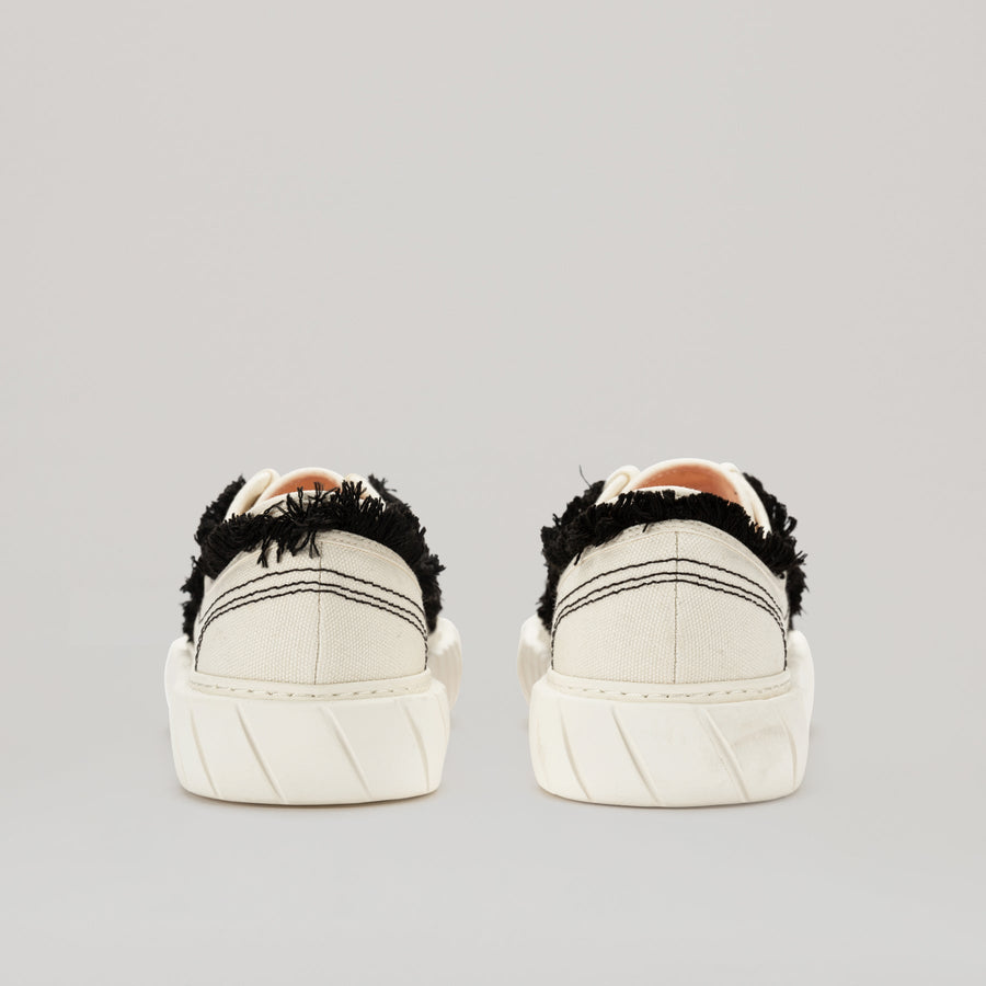 White FORMULA LOW sneaker with black fringe hem and EVA rubber sole