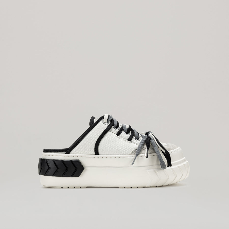 TYRES platform multi-laced mules in black and white with a comfortable platform and trendy pleather upper
