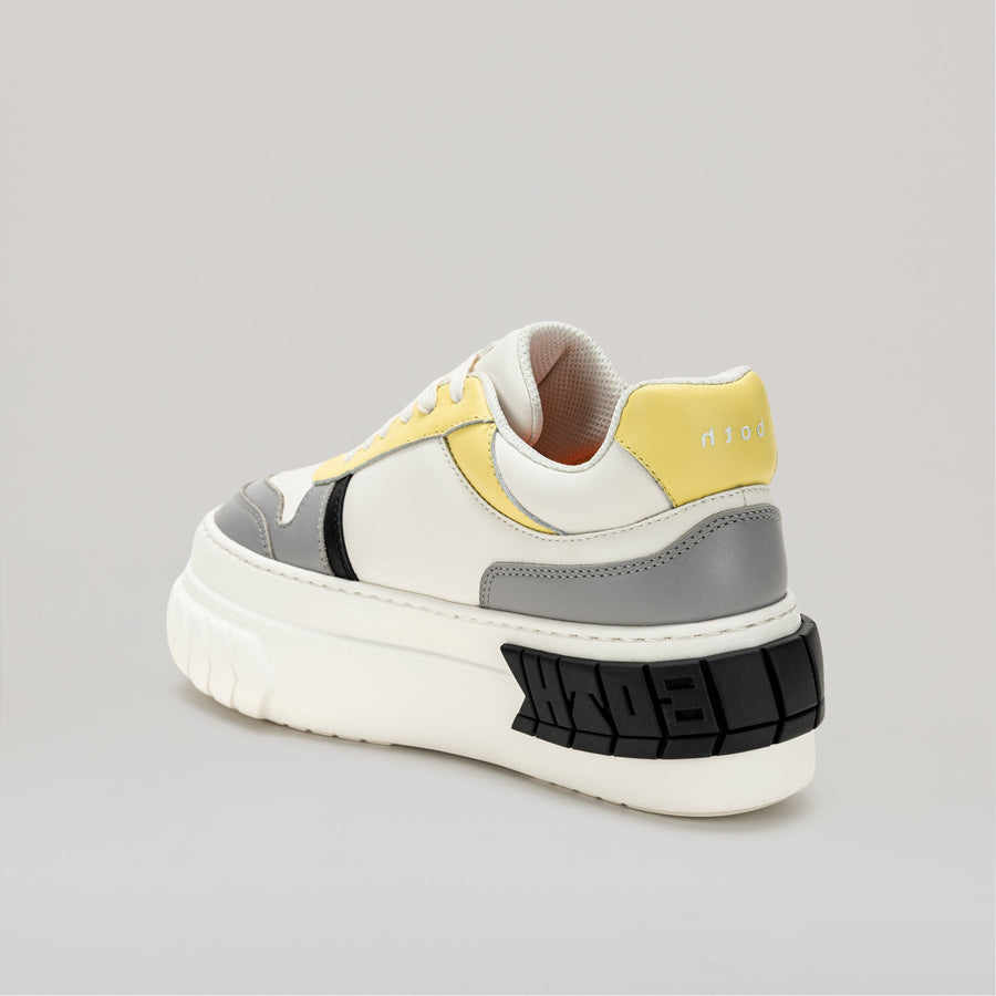 both TYRES platform basketball sneaker in black, yellow, white, and grey pleather design