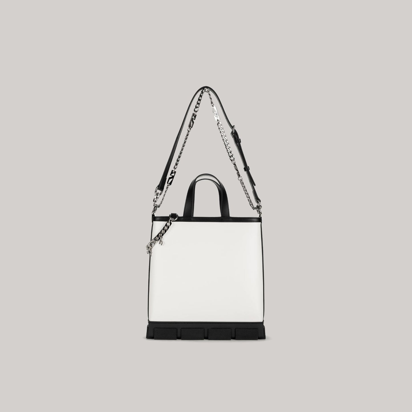 White and black GAO MINI TOTE BAG with detachable shoulder strap and chain detail on gray background