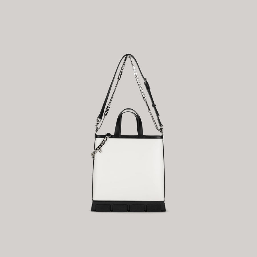 White and black GAO MINI TOTE BAG with detachable shoulder strap and chain detail on gray background
