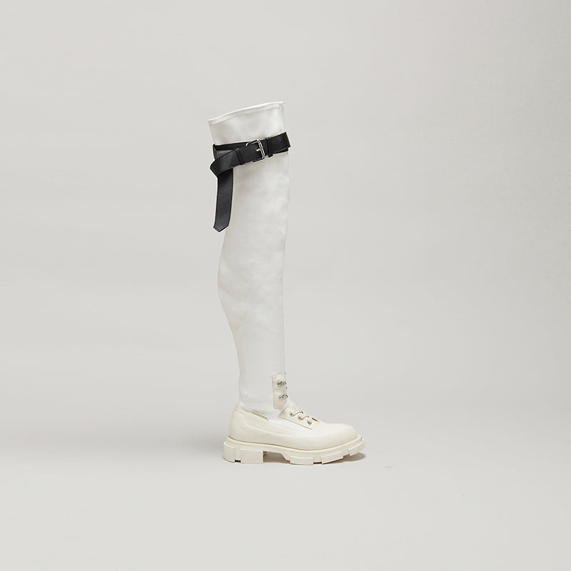 both X MONSE white thigh-high boot with black buckle detail and chunky sole