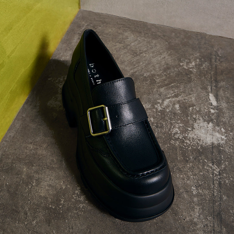 black platform buckled loafer from both x CHARLES & KEITH with polished buckle and thick sole on concrete floor
