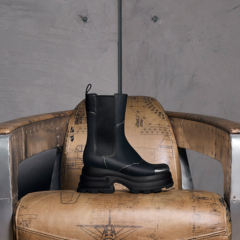 both x CHARLES & KEITH black Chelsea boot with chunky sole on vintage chair