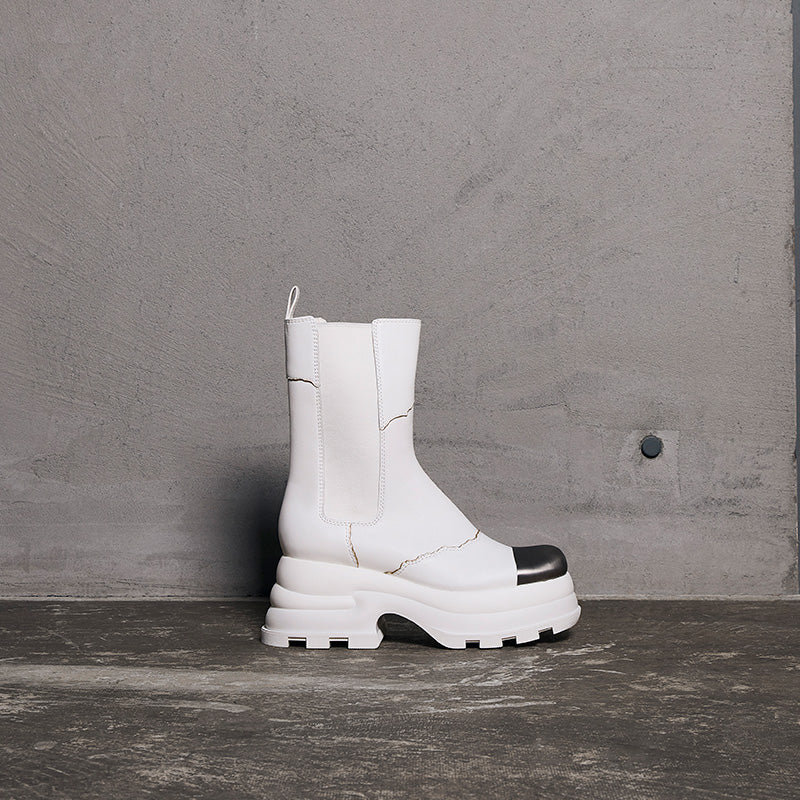 both x CHARLES & KEITH white Chelsea boots with chunky sole and black toe detail against gray background