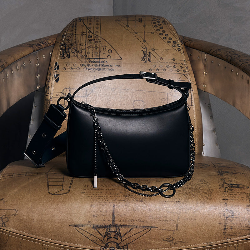both x CHARLES & KEITH black embellished bag on vintage leather chair