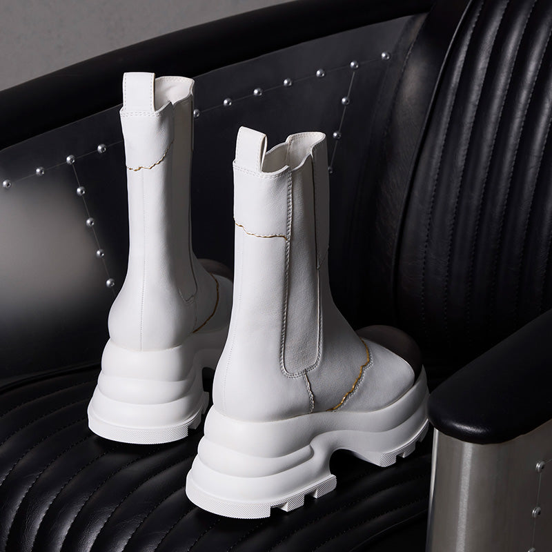 both x CHARLES & KEITH white Chelsea boots with chunky sole on black leather chair